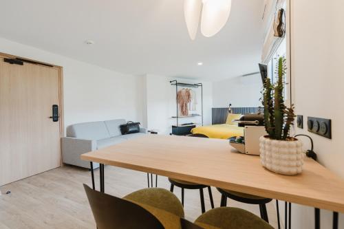 a living room with a wooden table and chairs at Appart Hotel Neostelia in Annecy