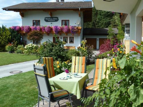 a table and chairs in front of a house at Haus Silvia in Werfenweng