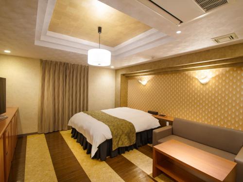 a hotel room with a bed and a couch at Hotel S in Nara