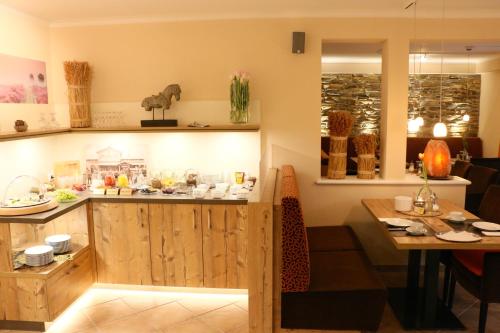 a kitchen with a counter and a table in a room at Hotel Pension Fortuna in Bad Bevensen