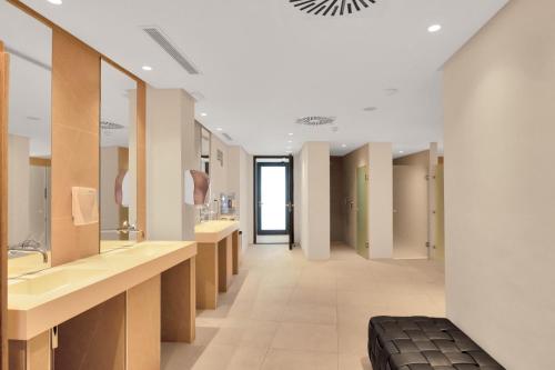 a bathroom with a row of sinks and mirrors at Extra large Luxury property with Spa, 3 min to Marbella city center in Málaga