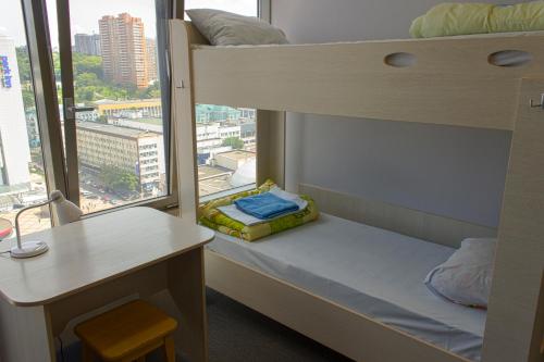 a bedroom with a bed and a window at Yak Olympic Hostel in Kyiv