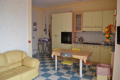 a kitchen with a couch and a table in a kitchen at casa vacanze dei navigatori on the sea in Pontecagnano