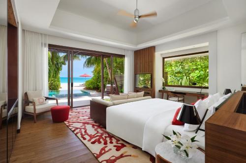 a bedroom with a bed and a view of the ocean at Niyama Private Islands Maldives in Dhaalu Atoll