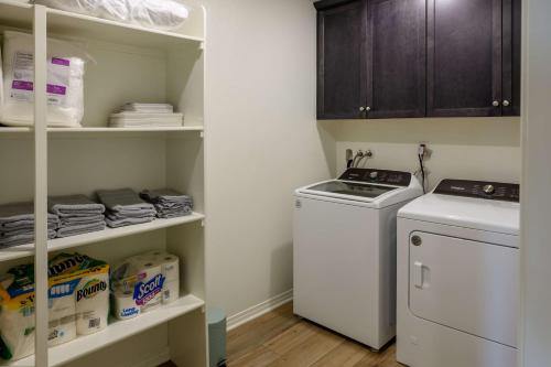 a small laundry room with a washer and dryer at 6BR Villa with POOL, BBQ, Temecula WINERIES in Winchester