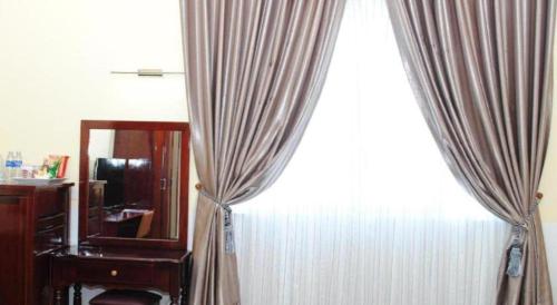 Postel nebo postele na pokoji v ubytování Tran Vinh Hotel