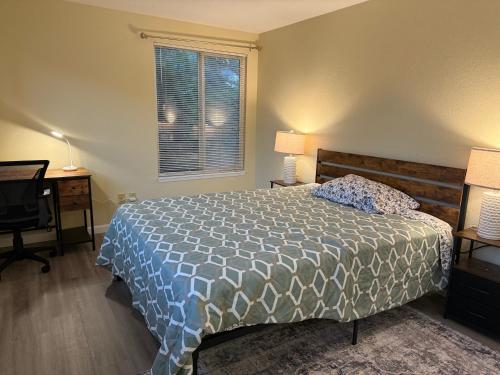 a bedroom with a bed and two lamps and a window at Private Room "Evergreen" by UW in Seattle