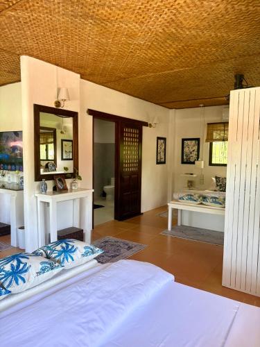 a bedroom with two beds and a mirror at Casa Manalo Guest House in Puerto Princesa City