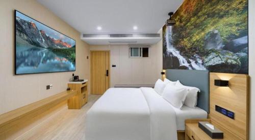 Cama o camas de una habitación en Sheng Lin Na Hotel Minzhi Branch