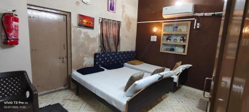 a small bedroom with a bed in a room at Ashirwad bunglow in Dwarka