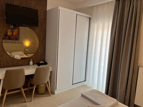 a bedroom with a desk and a mirror and a bed at Apartments Stoudios Georgias in Arkoudi