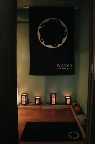 a room with a poster on the wall with candles at waves nakameguro in Tokyo