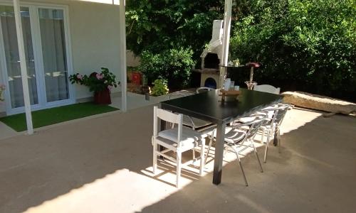 a black table and chairs on a patio at Apartman Vlatka in Kninsko Polje