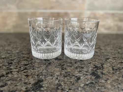 two clear glasses sitting on top of a counter at Lakefront Luxury Retreat Munyonyo in Kampala