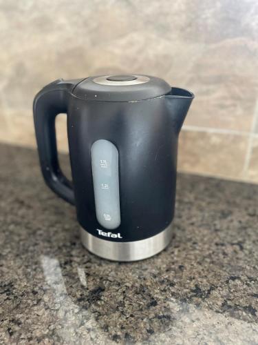 a black coffee pot sitting on a counter at Lakefront Luxury Retreat Munyonyo in Kampala