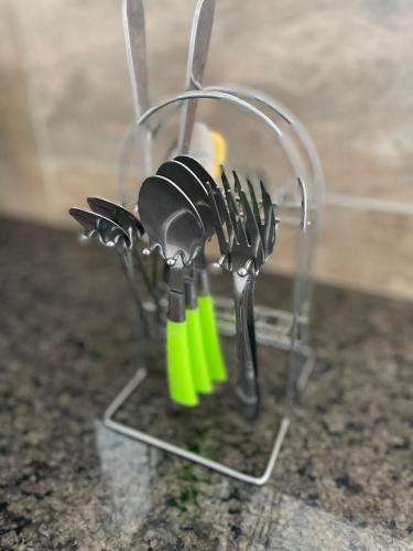 a glass knife holder on a counter with some knives at Lakefront Luxury Retreat Munyonyo in Kampala