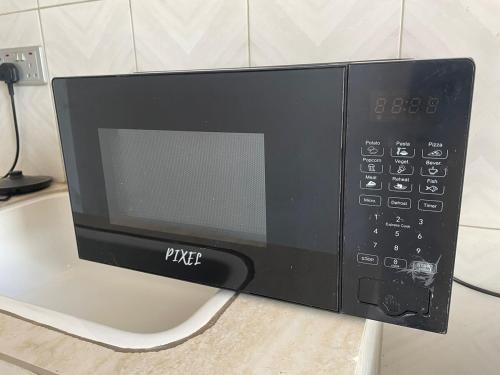 a microwave oven sitting on top of a counter at Lakefront Luxury Retreat Munyonyo in Kampala