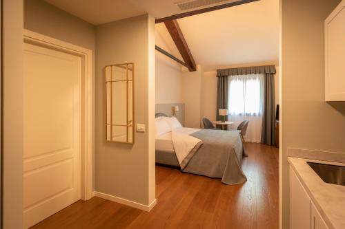 a bedroom with a bed and a window and a door at Castello di Porcìa - Residence Agrituristico in Porcia