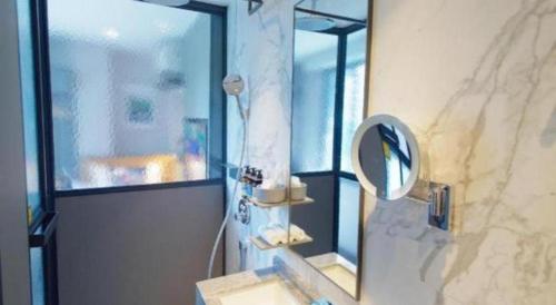 a bathroom with a sink and a mirror at Hotel Soloha @ Chinatown in Singapore