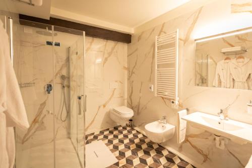 a bathroom with a shower and a toilet and a sink at Castello di Porcìa - Residence Agrituristico in Porcia