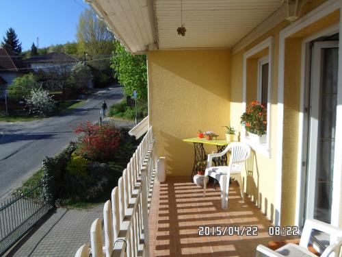 a porch with a table and chairs on a house at Accommodation close to Budapest in Solymár