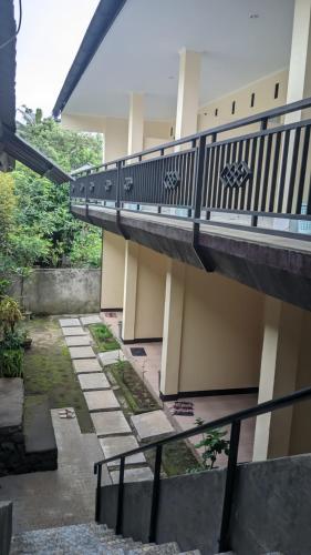 a balcony of a building with a walkway at Rinjani Homestay Senaru in Senaru