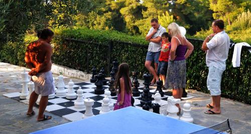 a group of people playing chess on a chessboard at Hotel Kriopigi in Kriopigi