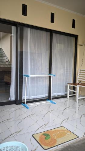 a room with large windows with blue tape at Rinjani Homestay Senaru in Senaru