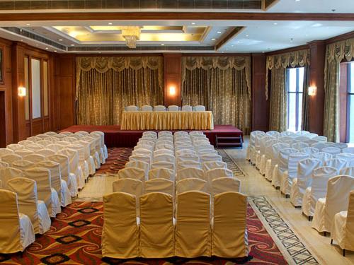 a banquet hall with rows of chairs and tables at Clarion Bella Casa at Airport in Jaipur