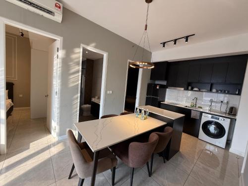 a kitchen and dining room with a table and chairs at Axon Suite Bukit Bintang By Luna in Kuala Lumpur