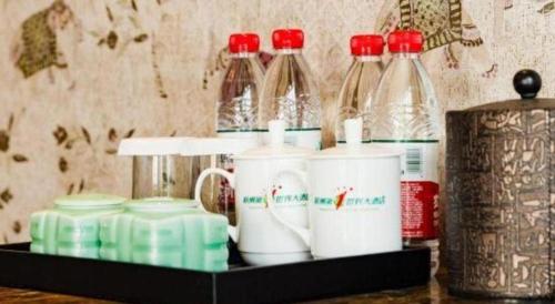 a shelf with cups and bottles on a table at Hangzhou The First World Hotel in Hangzhou