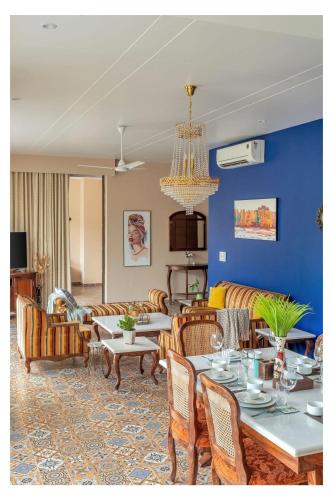 a living room with a couch and a table and chairs at Dia Hotels and Homes Nerul Goa - Villas and Apartments in Nerul