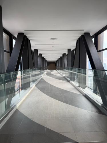 an empty hallway in a building with glass walls at Axon Suite Bukit Bintang By Luna in Kuala Lumpur