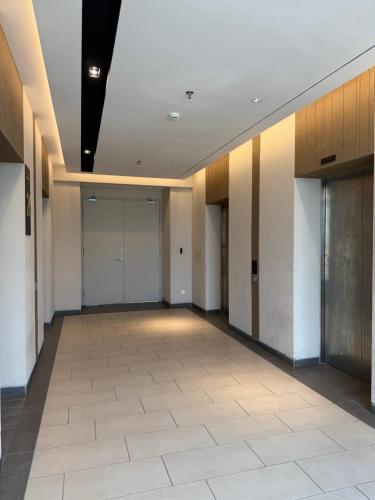 an empty hallway with a large room with white walls at Axon Suite Bukit Bintang By Luna in Kuala Lumpur