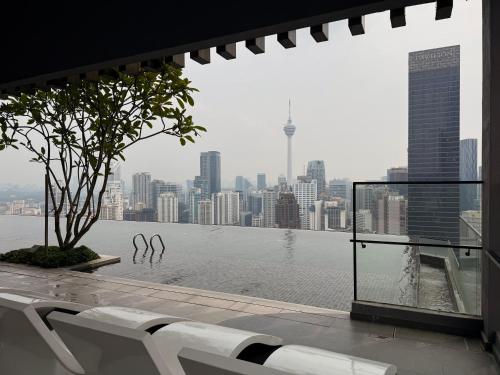 a view of the water from a building with a bench at Axon Suite Bukit Bintang By Luna in Kuala Lumpur