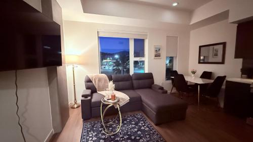 a living room with a couch and a table at One Lux Stay - Hollywood in Los Angeles