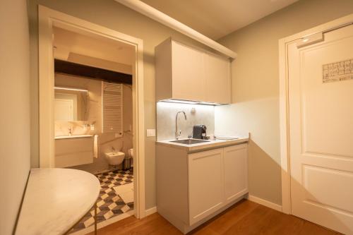 a small kitchen with a sink and a toilet at Castello di Porcìa - Residence Agrituristico in Porcia