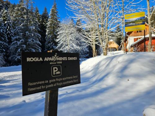 a sign in the snow in front of a resort at Glamping Tent Water Village Rogla in Oplotnica