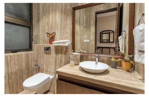 a bathroom with a sink and a toilet at Dia Hotels and Homes Nerul Goa - Villas and Apartments in Nerul