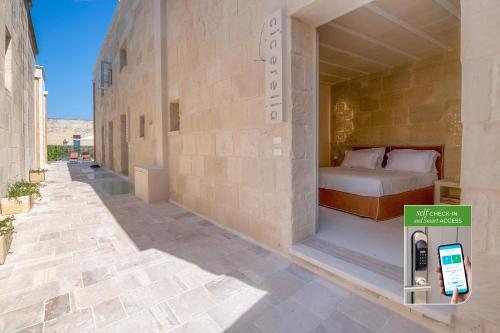 a room with a bed and a cell phone in a wall at Corte Dei Granai Meeting & SPA - Raro Rooms Collection in Maglie