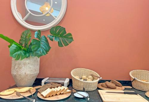a table with baskets of bread and a mirror at Soho Boutique Tetuán in Tetouan