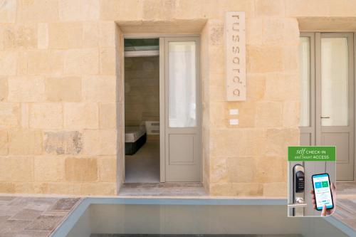 a building with a cell phone dispenser in front of it at Corte Dei Granai Meeting & SPA - Raro Rooms Collection in Maglie