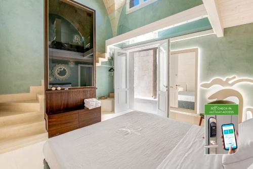 a bedroom with a bed and a sink and a mirror at Corte Dei Granai Meeting & SPA - Raro Rooms Collection in Maglie