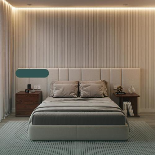 a bedroom with a large bed with a green headboard at Ataas Apartment Homes Islamabad in Dargai