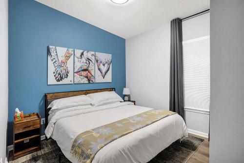 a bedroom with a large bed with blue walls at Close to everything downtown in Indianapolis
