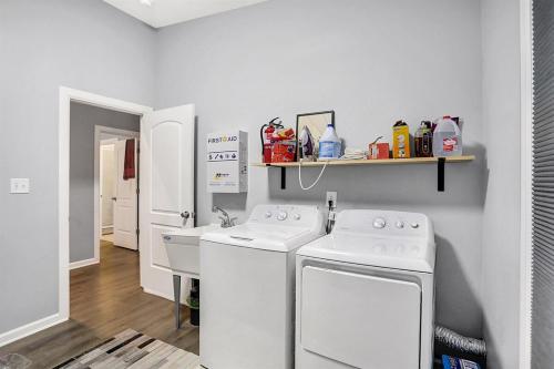 a laundry room with two washing machines and a sink at Close to everything downtown in Indianapolis