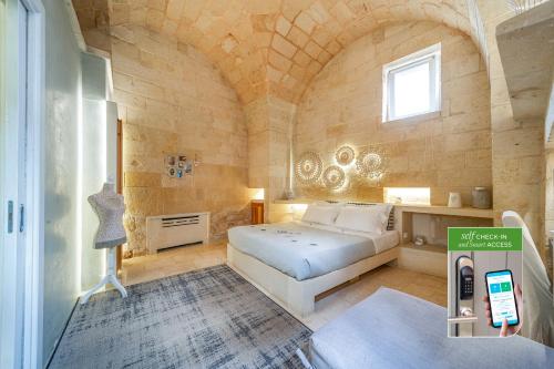 a bedroom with a bed and a phone in a room at Corte Dei Granai Meeting & SPA - Raro Rooms Collection in Maglie