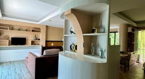 a living room with a couch and a living room with at Phi Phi Nice Beach Hotel Hip in Phi Phi Don
