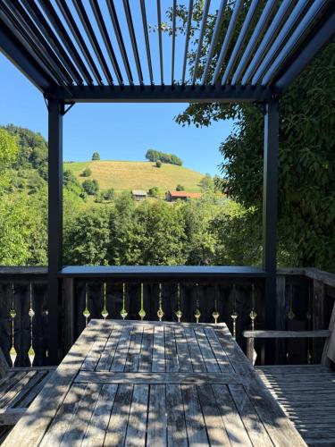 a wooden deck with a view of a hill at Stunning Hills View Apartment Vransko in Vransko