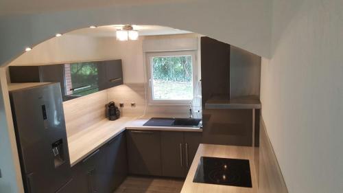 a small kitchen with a sink and a window at Cite Espace Apartment in Toulouse